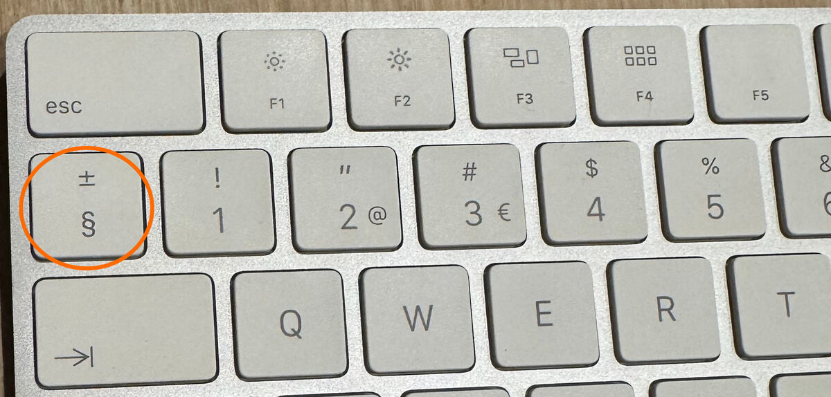 Partial view of a Mac keyboard showing the section key location